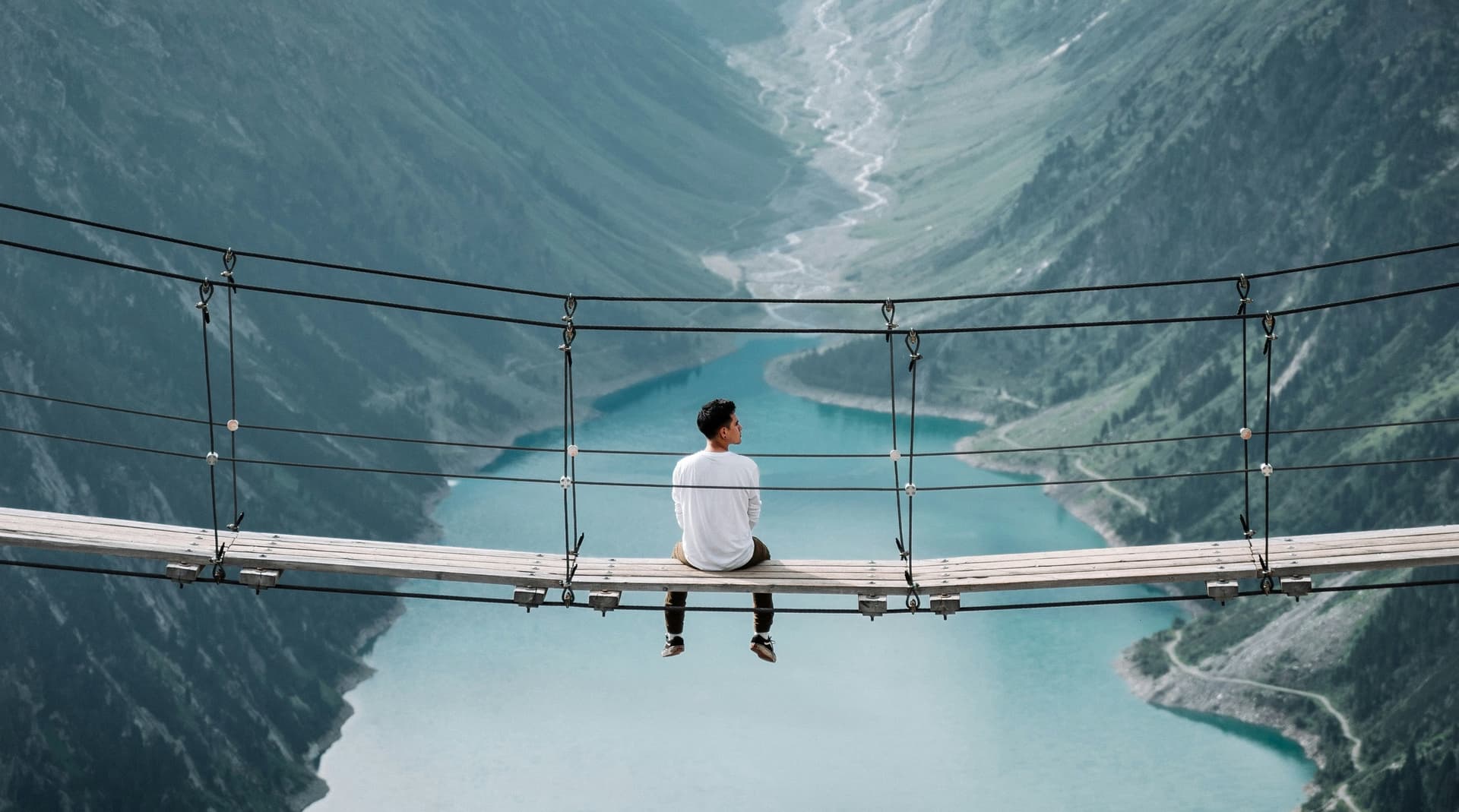 Man sit on the cable bridge